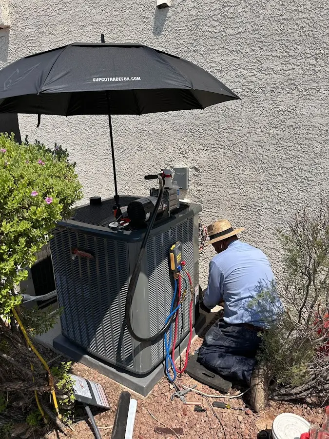 HVAC technician performing outdoor AC maintenance in Laurinburg